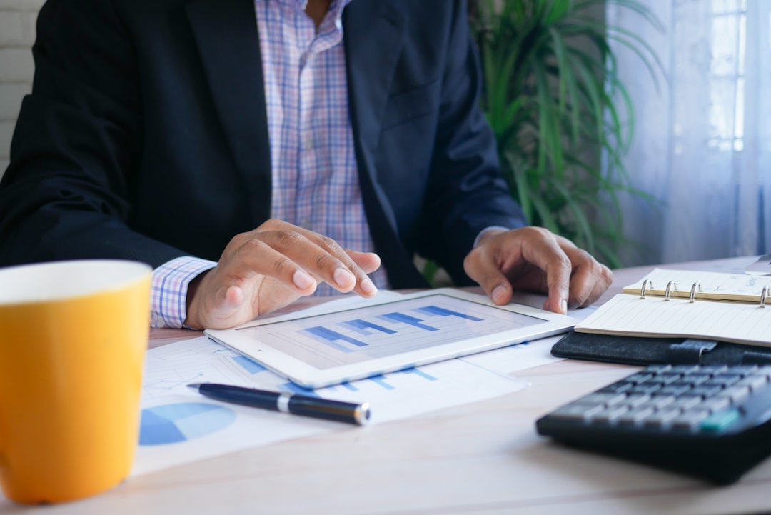 Accountant comparing bookkeeping outsourcing UK options against hiring in-house